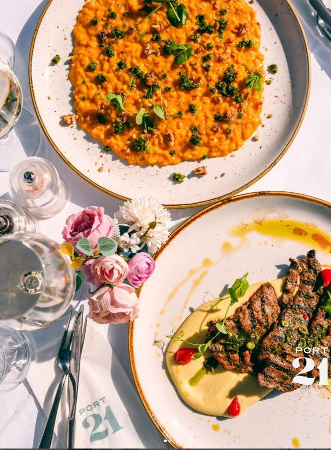 Risotto and grilled meat seen from above, with fresh flowers